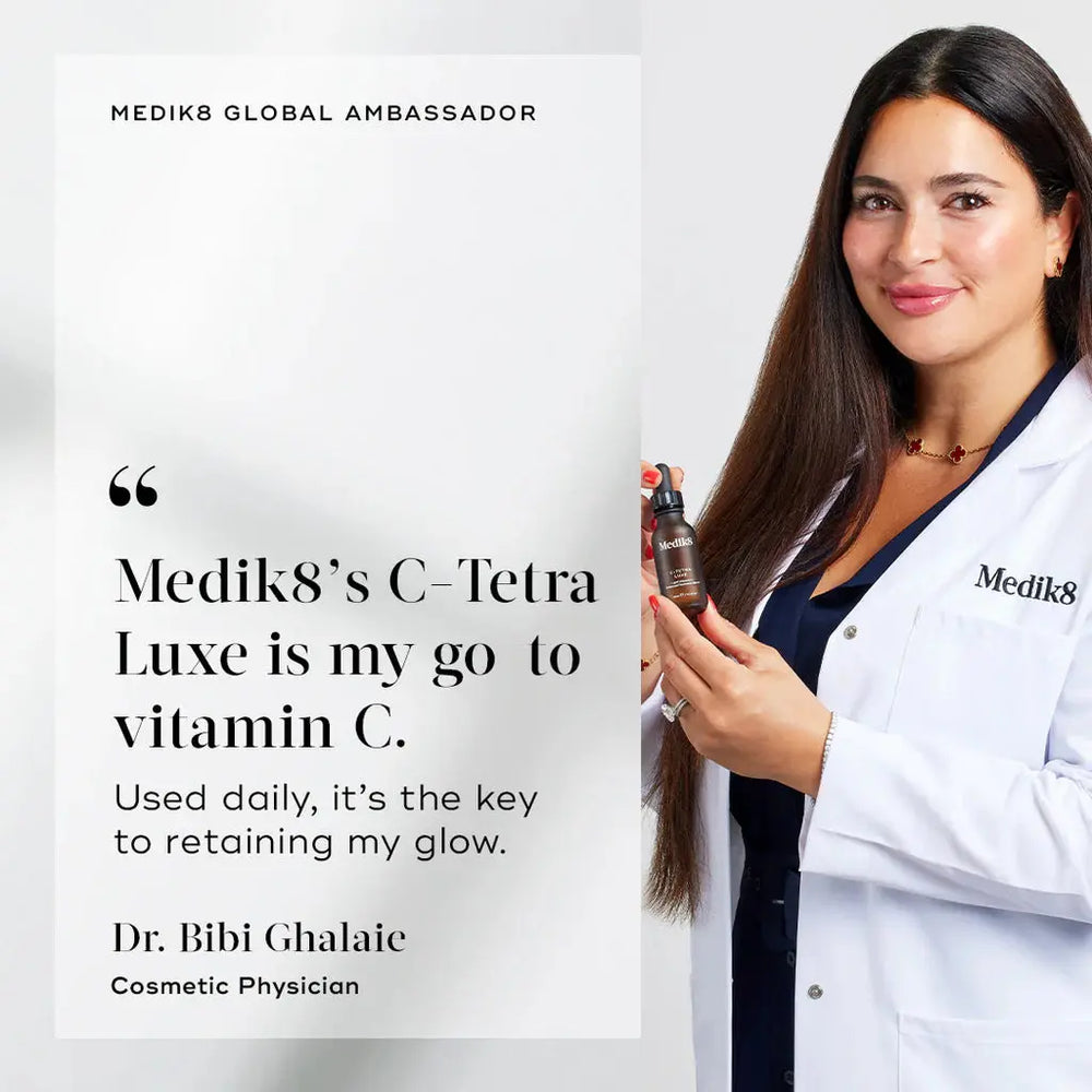 Woman in a lab coat holding a bottle of Medik8 C-Tetra Luxe, with text about it being a go-to vitamin C product.