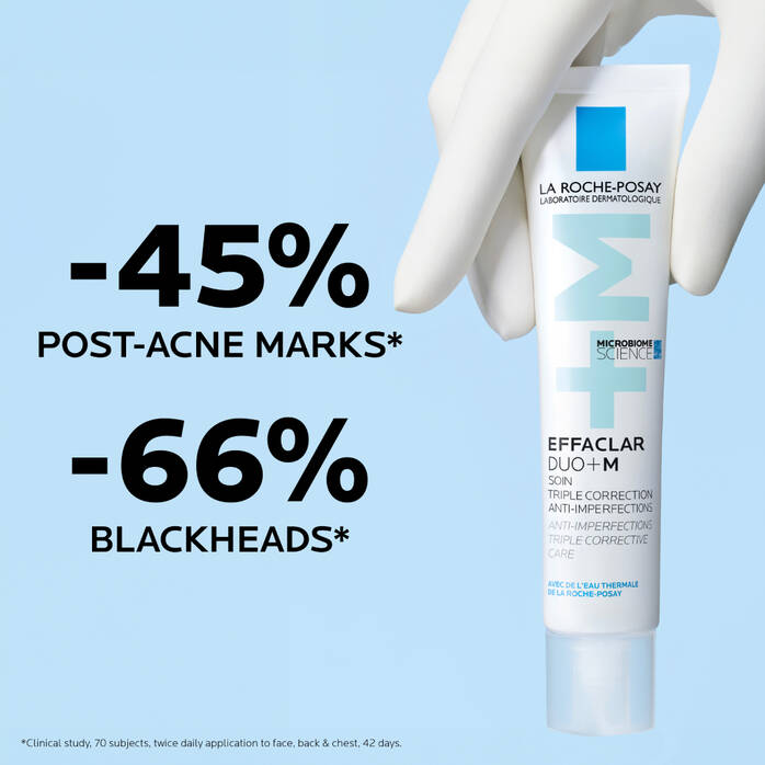 La Roche-Posay Effaclar Duo+M tube with gloved hand on light blue background