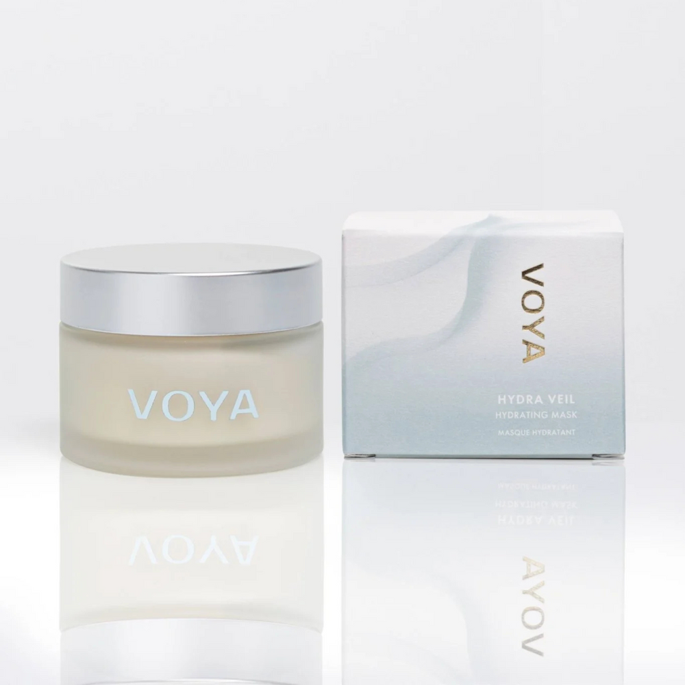 Voya Hydra Veil Hydrating Face Mask in glass jar with lid next to its box, a drink of water for the skin