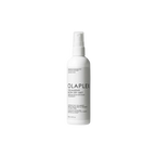 A white spray bottle labeled Olaplex Volumising Blow Dry Mist, with product information and branding visible.