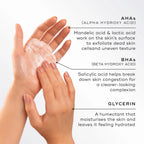 Hands applying Medik8 Surface Radiance Cleanse with text explaining benefit of key ingredients (AHAs, BHAs, and Glycerin)