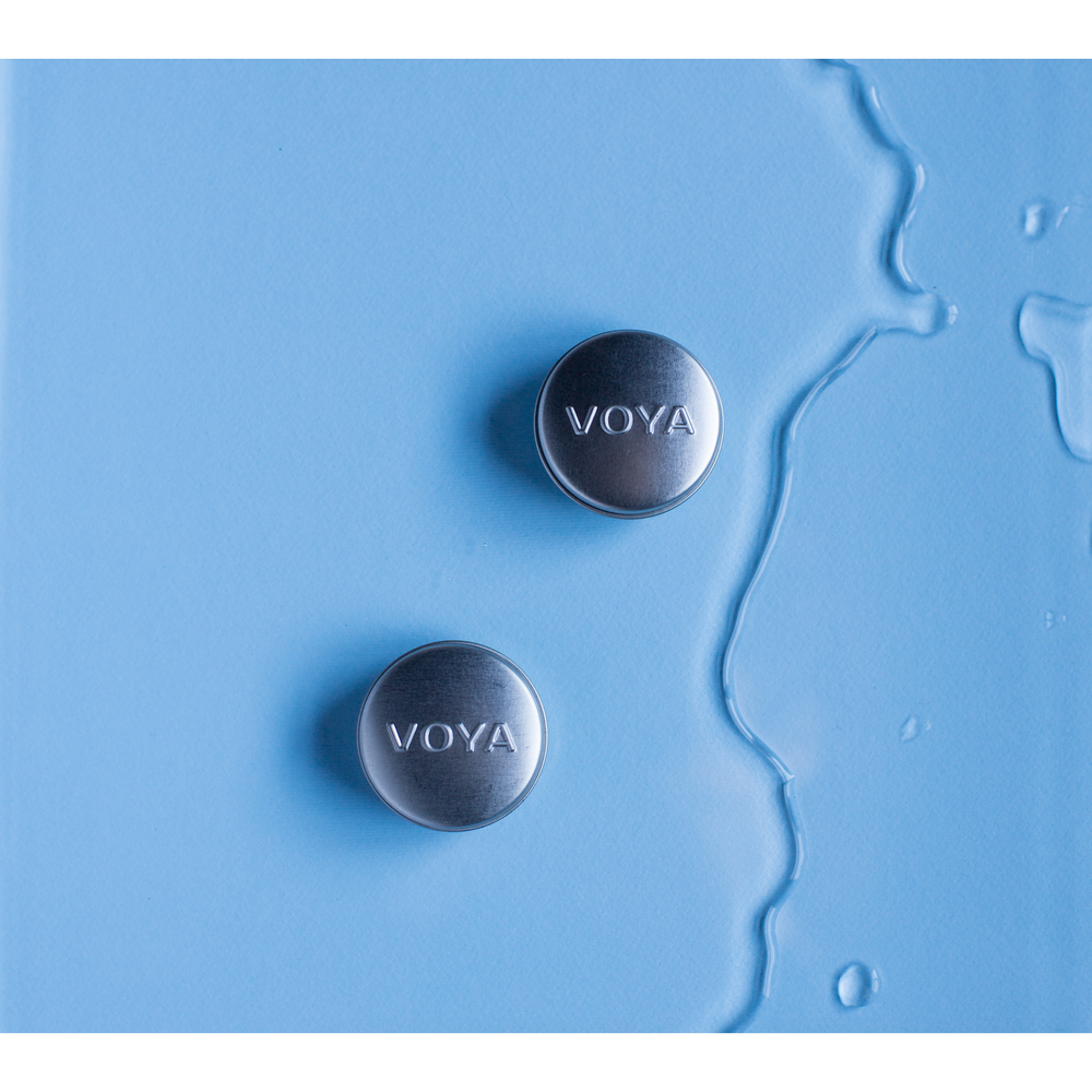 2 voya balmelicious tins on a blue background