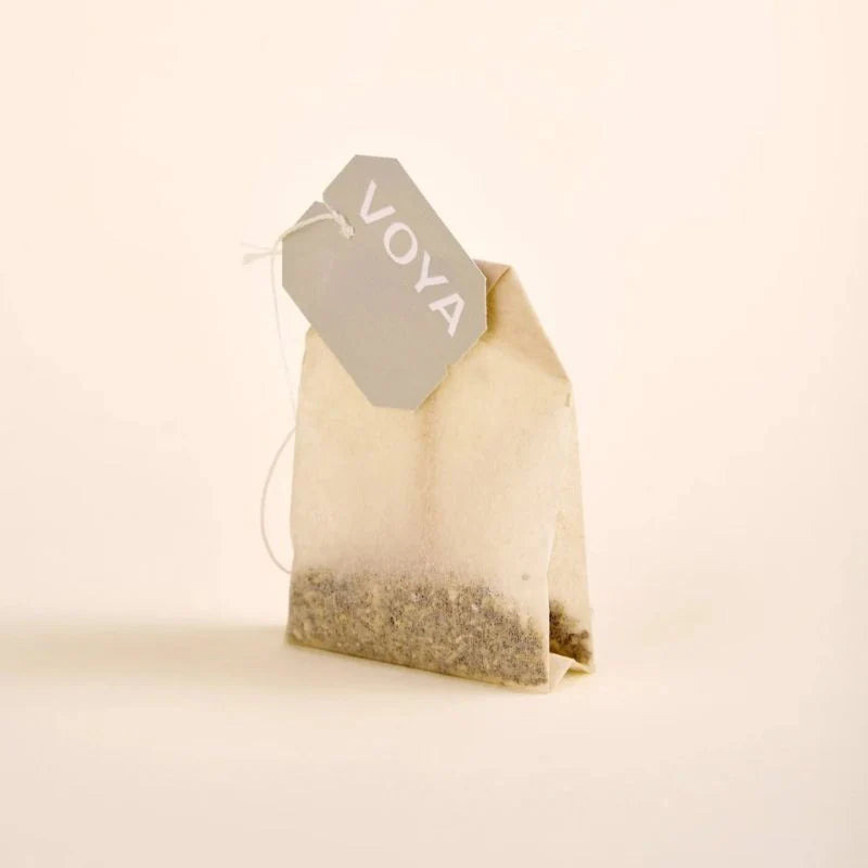 Tea bag with a 'Voya' tag on a beige background