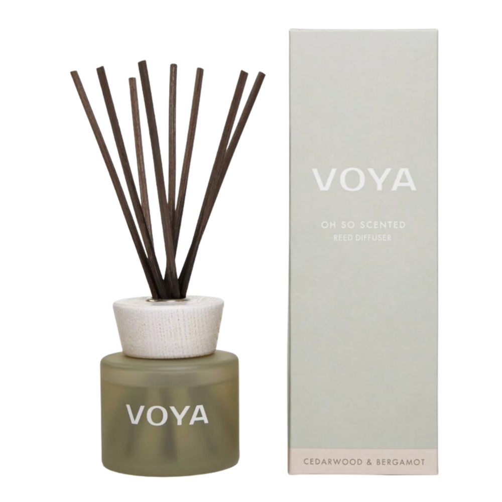 A VOYA reed diffuser with cedar and bergamot scent, consisting of a glass bottle, decorative cap and a bundle of reed sticks.