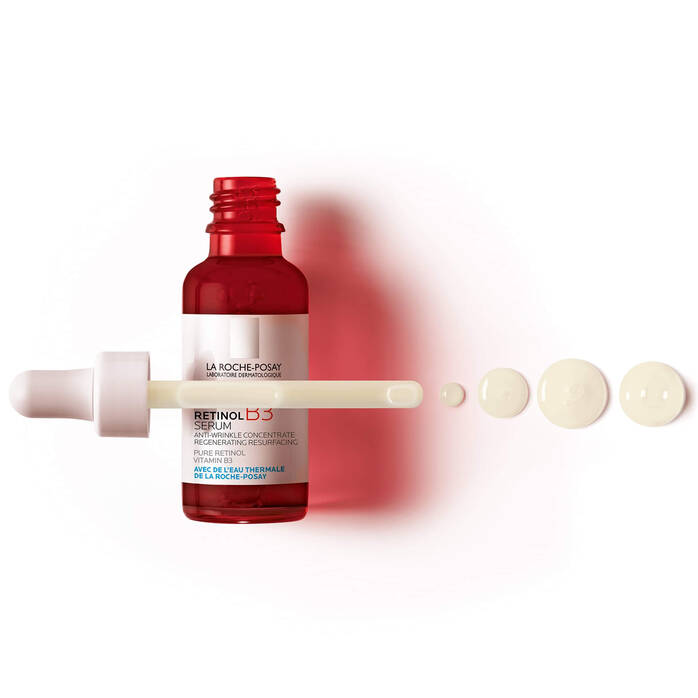 La Roche Posay Retinol B3 serum Red bottle with applicator and droplets on a white background