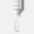 White cosmetic applicator with text on a light gray background