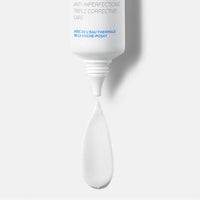 White cosmetic applicator with text on a light gray background