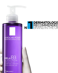 Purple bottle of La Roche-Posay Mela B3 gel with a hand holding it, on a white background.