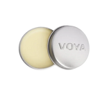 A round tin container of VOYA Lemon & Lime Organic Lip Balm, lid off, showing the balm inside.