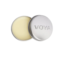 A round tin container of VOYA Lemon & Lime Organic Lip Balm, lid off, showing the balm inside.