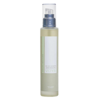 A clear bottle of Voya Oh So Scented Luxury Room Spray with a white label and spray nozzle, filled with a yellow liquid.