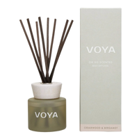 A VOYA reed diffuser with cedar and bergamot scent, consisting of a glass bottle, decorative cap and a bundle of reed sticks.