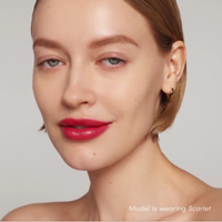 Close-up of a model wearing Jane Iredale Colorluxe lipstick in 'scarlet' with a neutral background