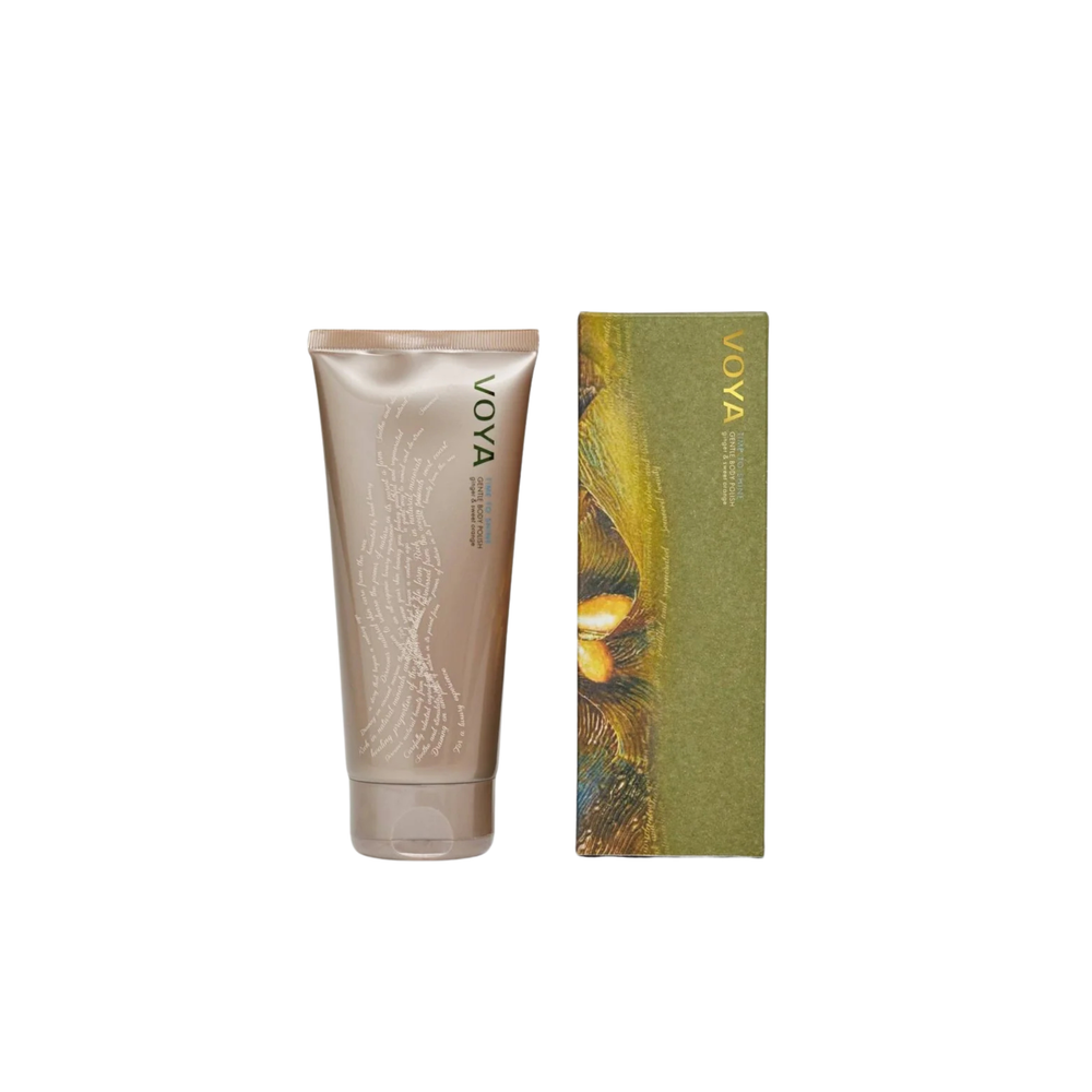 Voya Time To Shine Gentle Body Polish in gold tube packaging next to it 