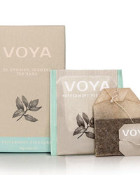Voya tea packaging with boxes and a tea bag on a white background