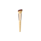 A beige contouring and blending brush with a large, angled top and a branded handle.