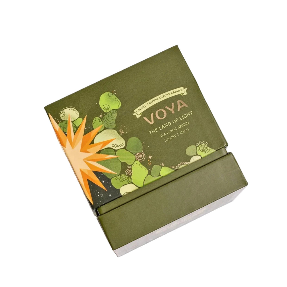 Green VOYA The Land of Light Christmas candle box with 'Voya' branding on a white background