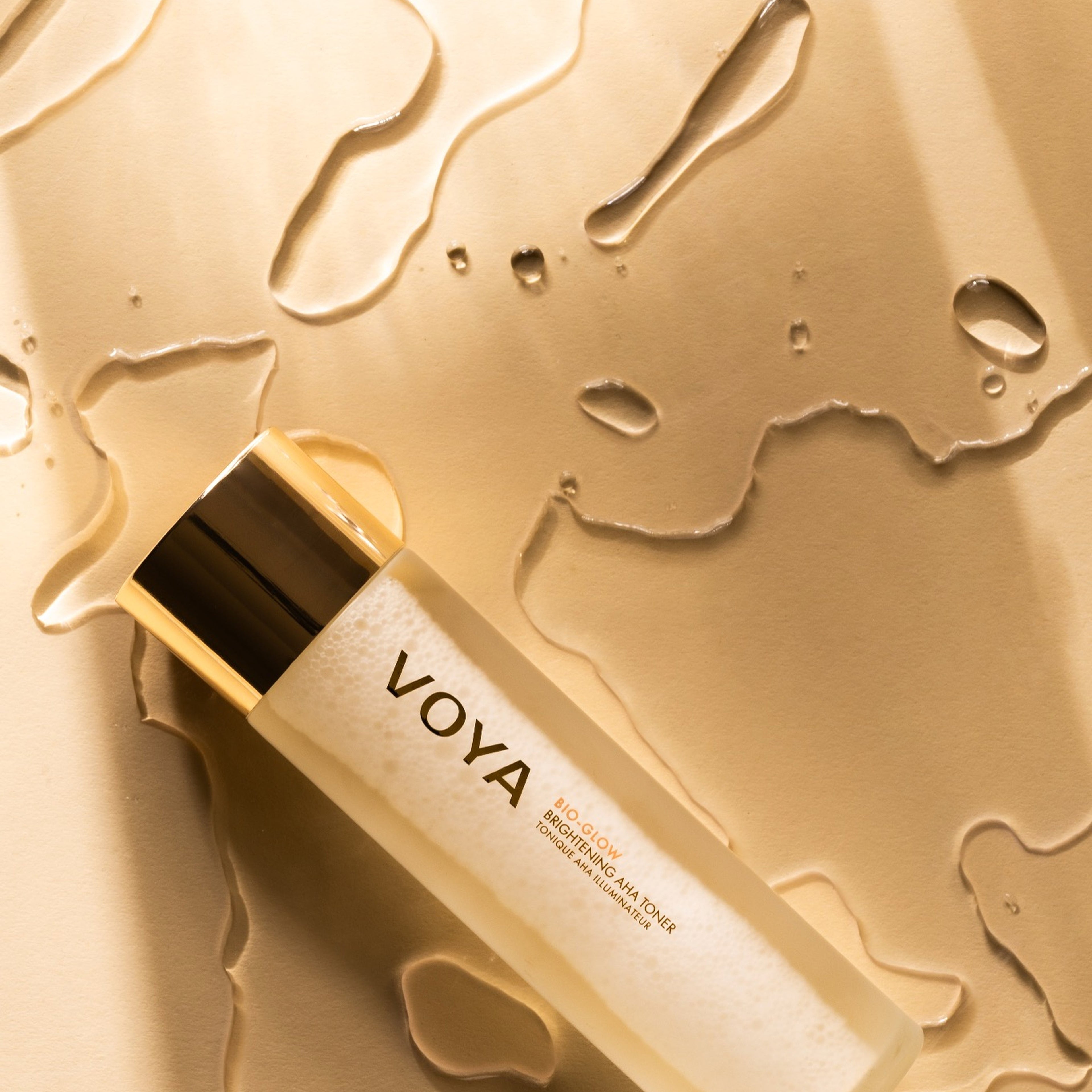 Voya Bio-Glow skincare bottle on a gold background