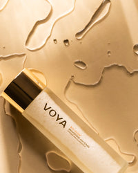Voya Bio-Glow skincare bottle on a gold background