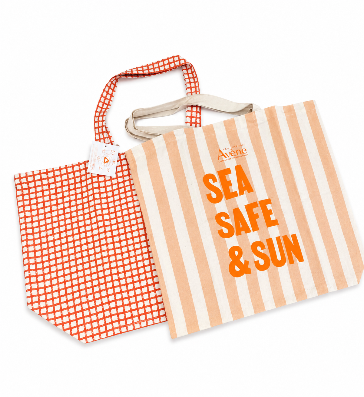 Striped tote bag with 'SEA SAFE & SUN' text and checkered pouch on a white background
