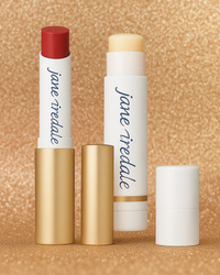 Set of Jane Iredale lip products on a gold glitter background. 