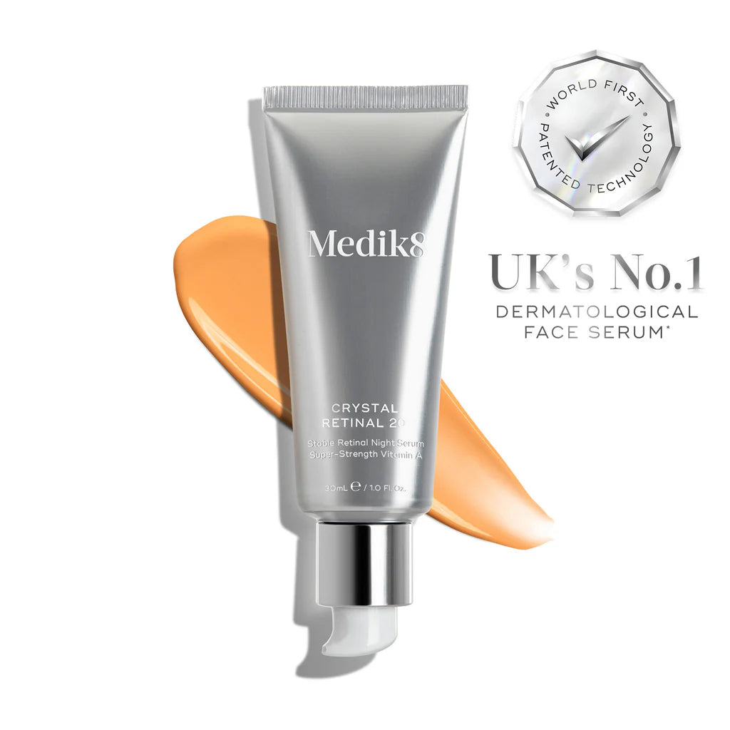 Medik8 Crystal Retinal 2 serum bottle with orange sample on a white background