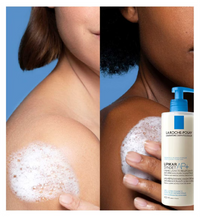 Two people with soapy shoulders and a bottle of La Roche-Posay Lipikar product.