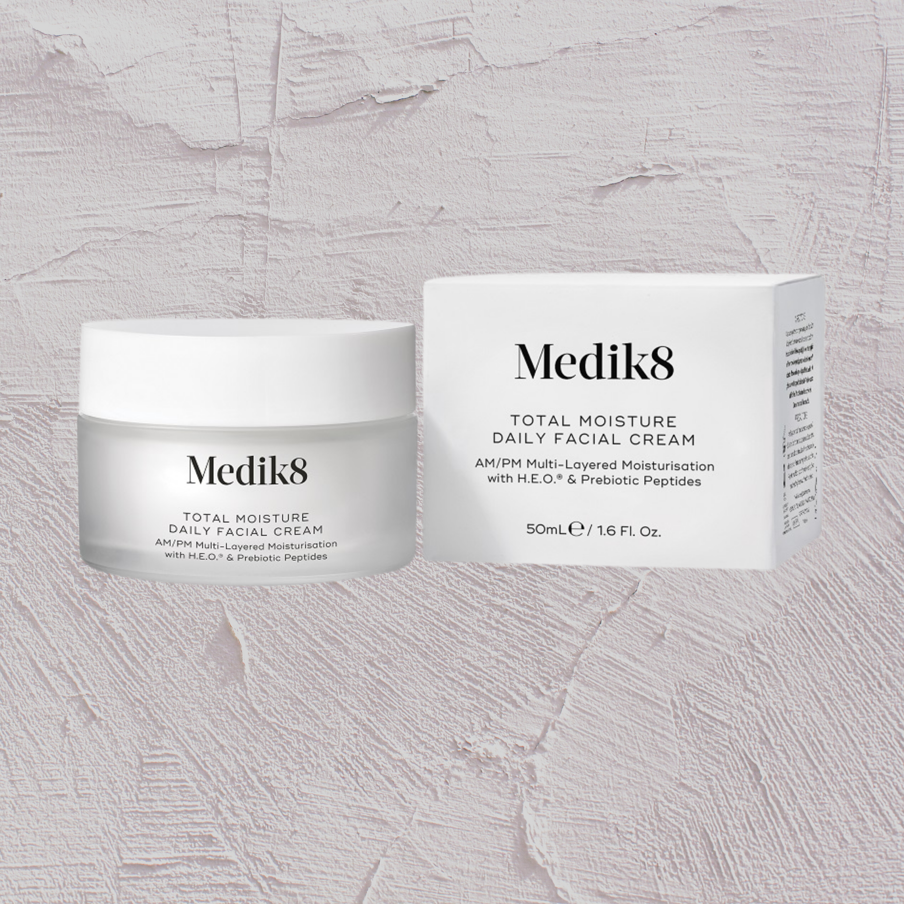 Medik8 Total Moisture Daily Facial Cream jar and box on a textured gray background