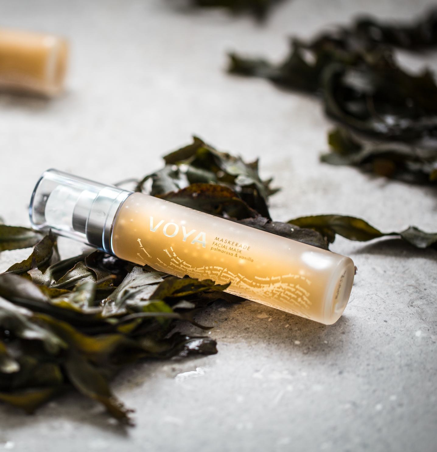 VOYA Maskerade pump Bottle gel mask on a beach with Seaweed