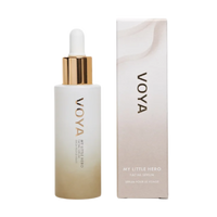 A VOYA My Little Hero bottle with a white label and a gold dropper containing facial serum, alongside its packaging box.