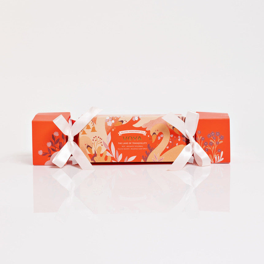 Packaged VOYA The Land of Tranquility cracker product with a decorative ribbon on a white background