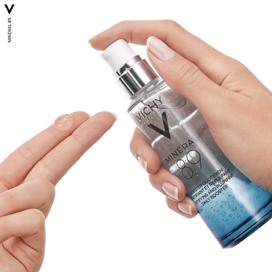 Vichy Minéral 89 skincare bottle held by a hand on a white background