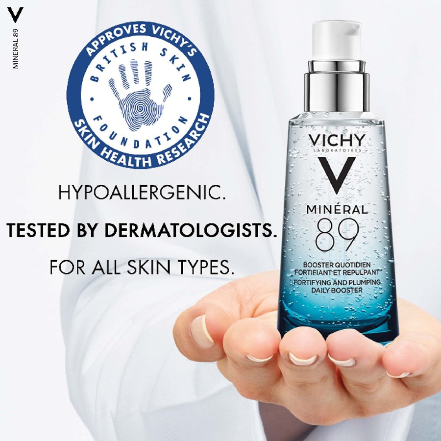 Vichy Minéral 89 bottle held in a hand with branding and text on a white background