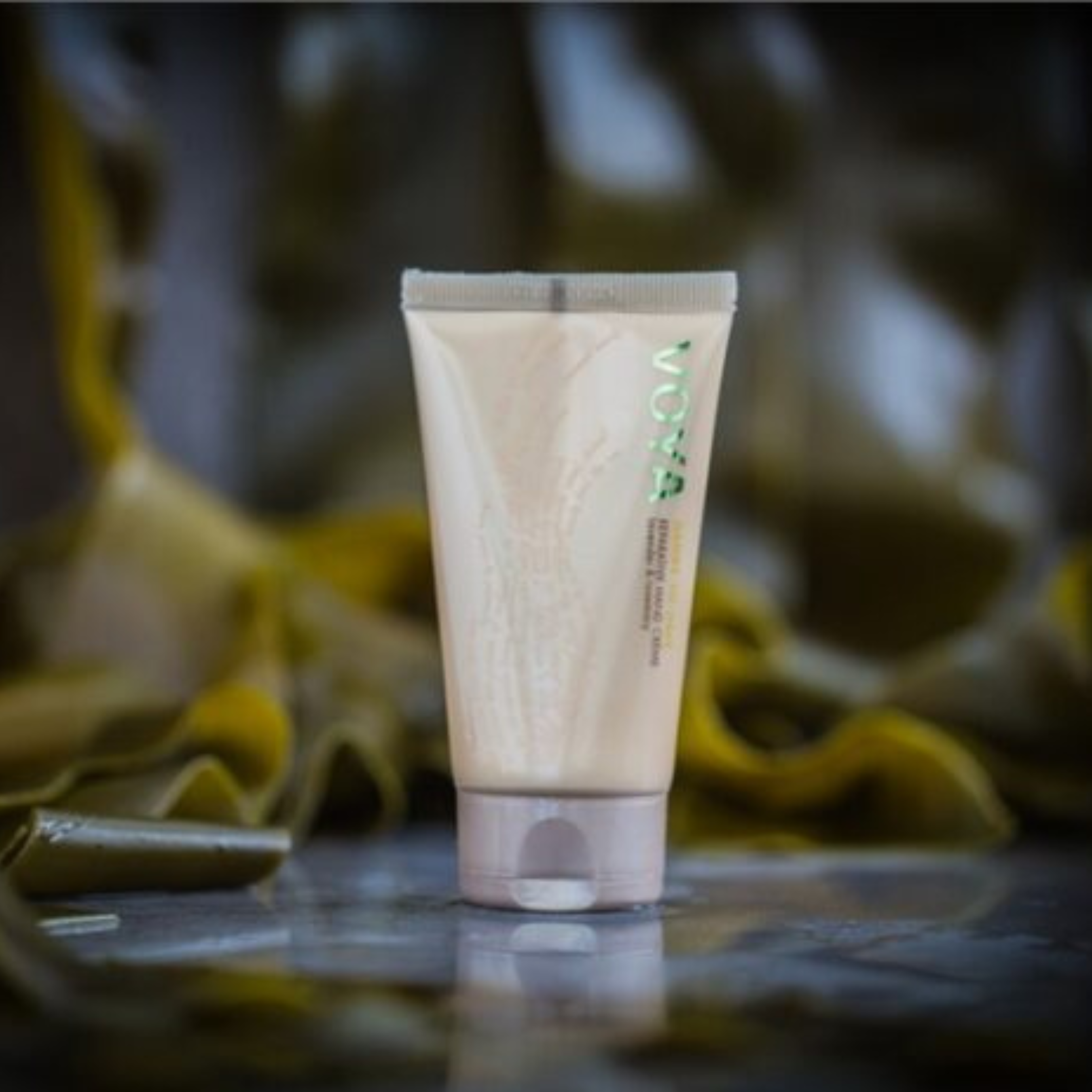 Voya Handy To Have Reparative Hand lotion in gold tube packaging next to its box