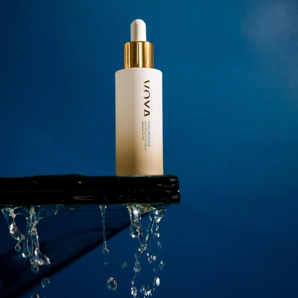VOYA Hyaluronate Anti-Pollution Serum 30 ml skincare dropper bottle on a reflective surface with a blue background