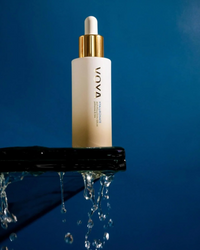 VOYA Hyaluronate Anti-Pollution Serum 30 ml skincare dropper bottle on a reflective surface with a blue background