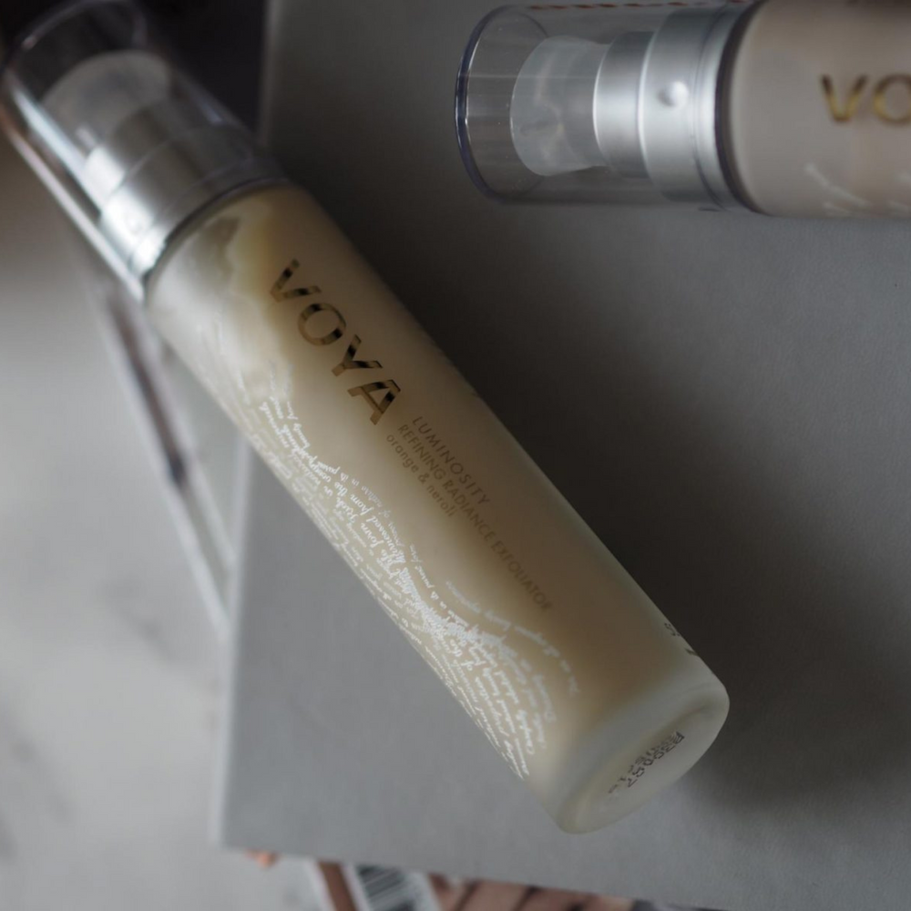 VOYA Luminosity Refining Radiance Exfoliator in glass bottle with pump and clear plastic lid