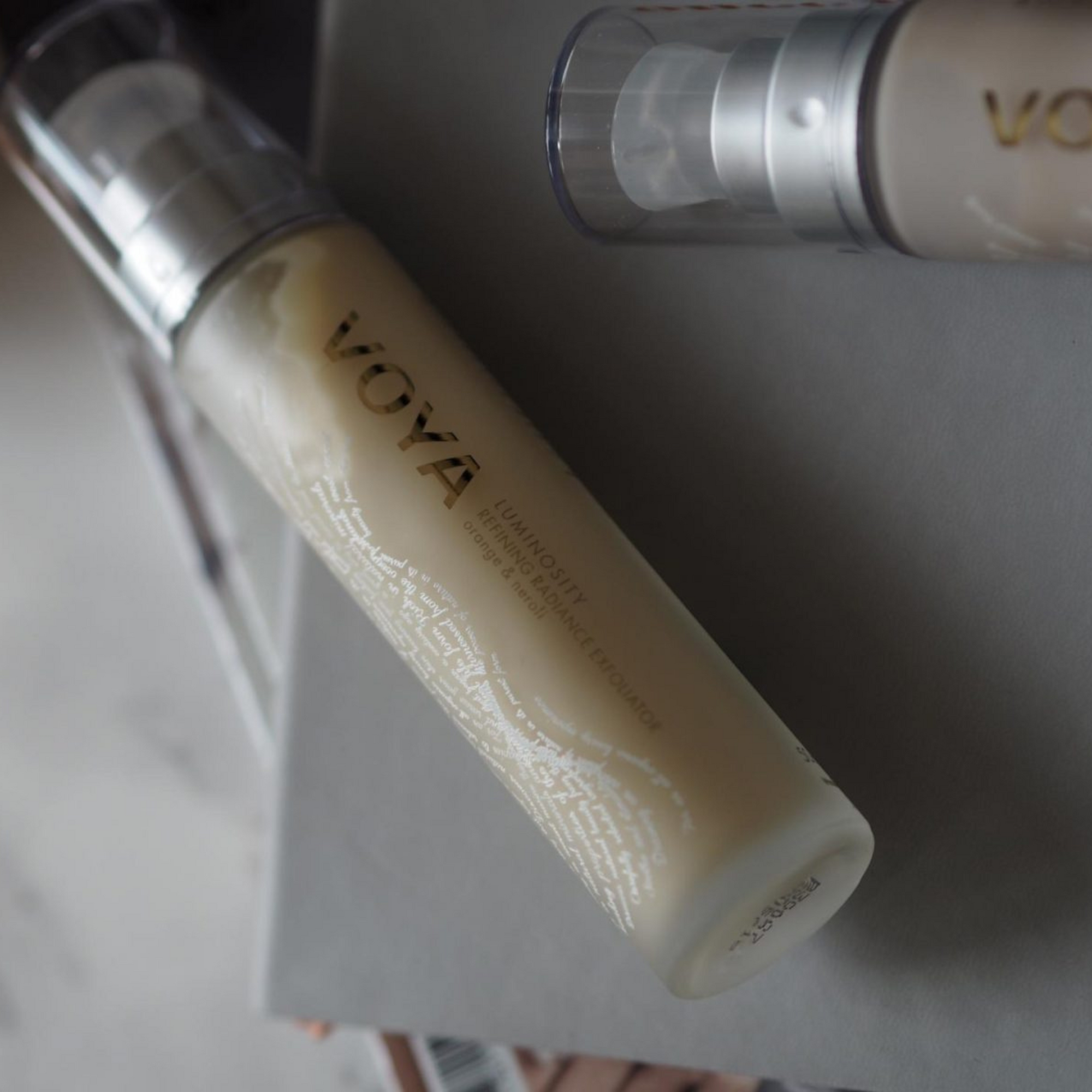 Voya Luminosity Refining Radiance Exfoliator in glass bottle with pump and clear plastic lid