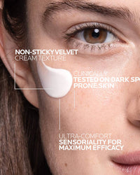 Close-up of a woman's face with cream applied, highlighting product features.