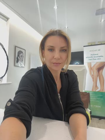 a woman sitting at a table with her hand on the table