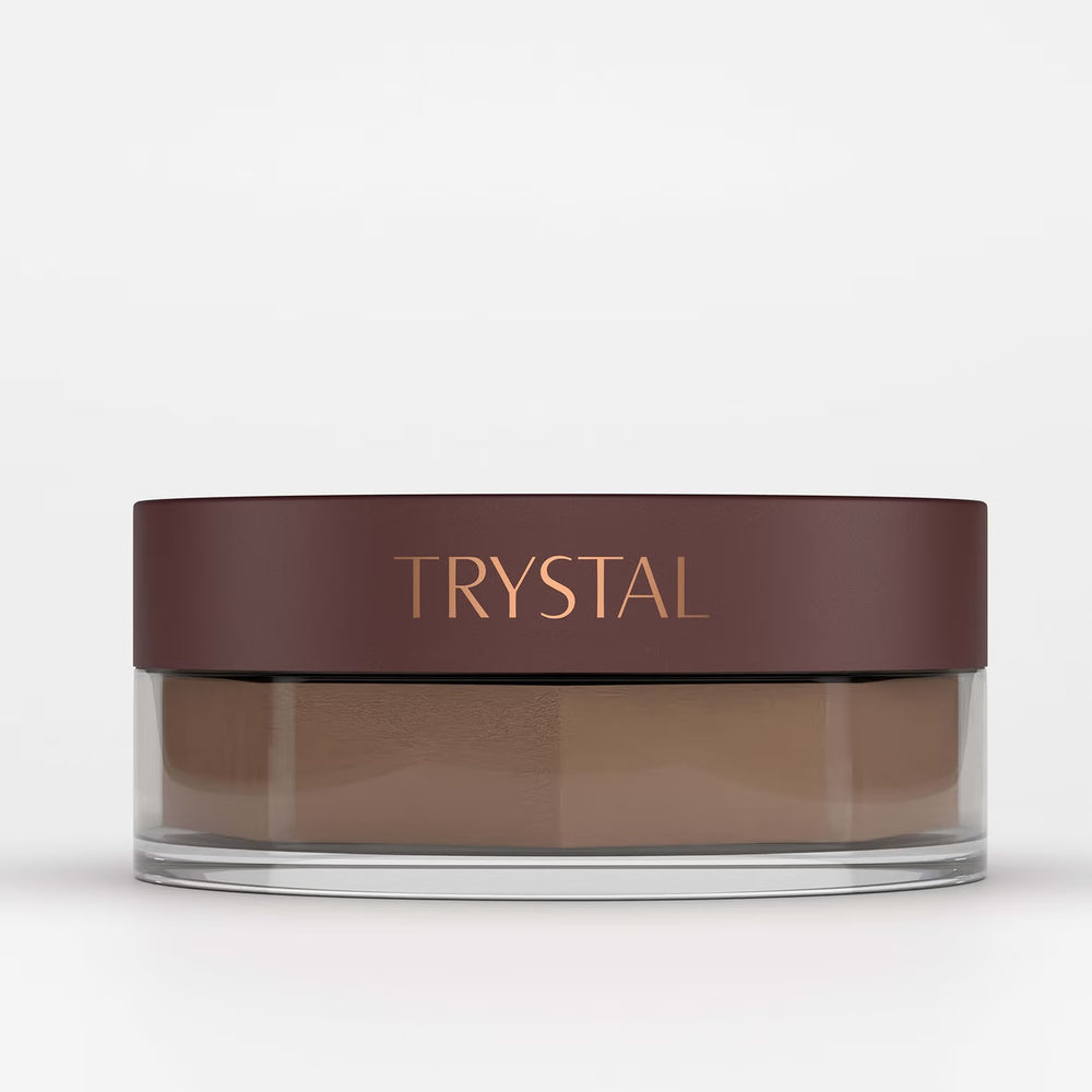 Jar of bronzing powder with 'TRYSTAL' branding on a white background