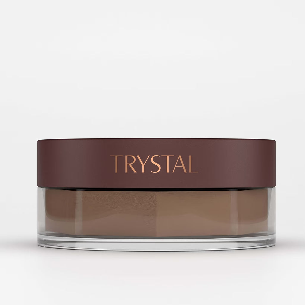 Jar of bronzing powder with 'TRYSTAL' branding on a white background
