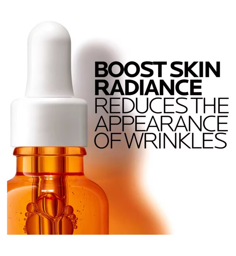 Skincare dropper bottle with text about skin radiance and wrinkle reduction on a white background